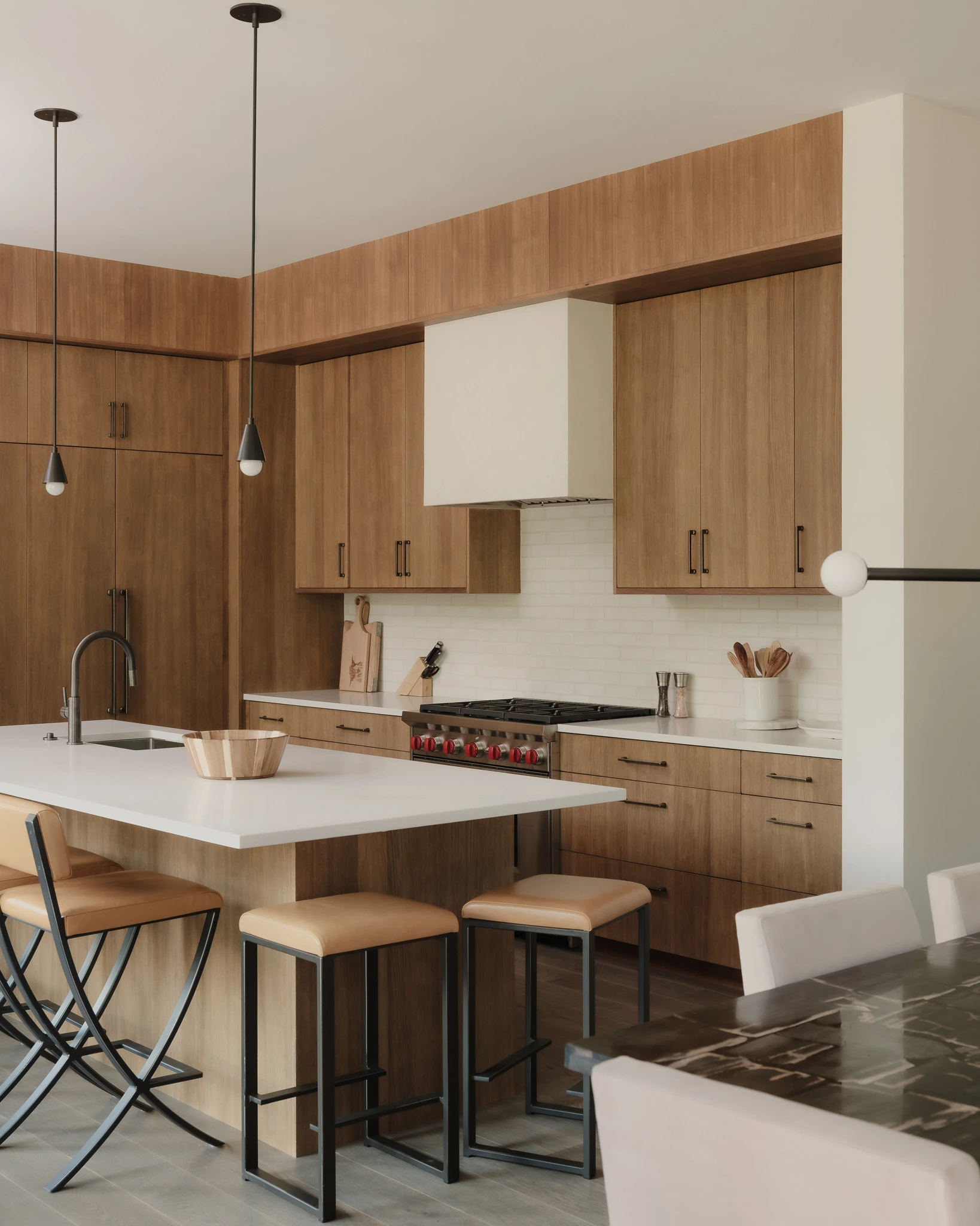 Kitchen with walnut cabinetry and waterfall island — interior design photography Big Sky Montana, Reid Smith Architects